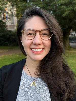 Marie Spiker, a young white woman with large tortoiseshell glasses and long dark brown hair